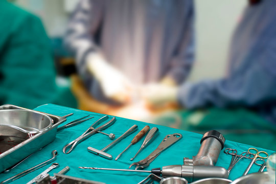 Tool for Orthopedic surgery, On a blurred background of surgeon team.