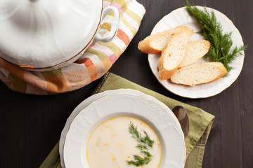 Creamy fish soup with salmon, potatoes, onions and carrots. Finnish cuisine. Top view