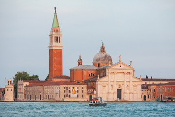Fototapeta na wymiar VENICE, ITALY - JUNE 15, 2016: View across the water of the Giudecca Canal to the island of San Georgio Maggiore, with its campanile and church designed by Palladio, Venice, Italy