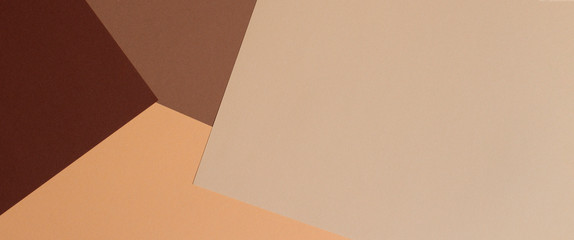 Color papers geometry composition banner background with beige, light brown and dark brown tones.