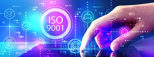 ISO 9001 with hand pressing tablet computer screen