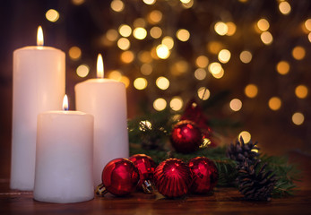 Tree branches, cones, bokeh lights, candles, Christmas balls . Preparation for the New year