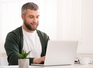 Middle aged businessman enjoying his job, working from home