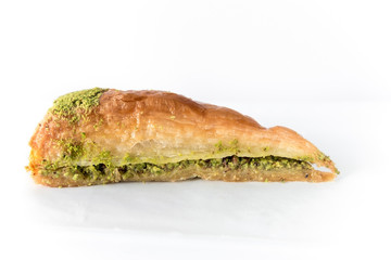 Turkish traditional dessert called Baklava with pistachios on a white background, close up