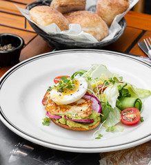 avocado toast topped with raddish, syrniki and boiled egg served with fresh salad