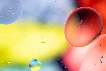 Abstract rainbow color backdrop with oil drops and waves on water surface. 3d render illustration