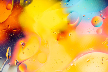 Abstract rainbow color backdrop with oil drops and waves on water surface. 3d render illustration