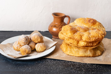 Mix of mexican and spanish fritter also called "buñuelos" on rustic background