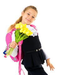 Little girl goes to school with a bouquet of flowers.