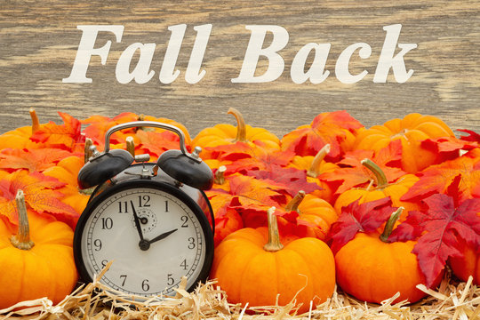 Fall Back Time Change Message With A Retro Alarm Clock With Pumpkins And Fall Leaves