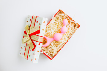 Christmas or New Year composition. Pink anal balls in a gift box on white background. Image for the...