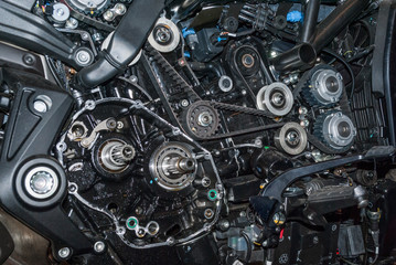 Fototapeta na wymiar inside view of complex motorbike engine showing belts cogs and wheels lots of detail