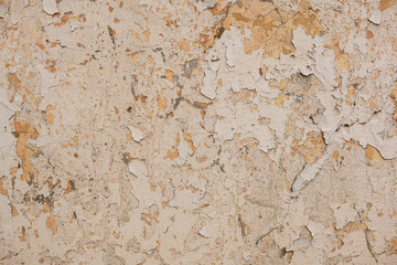 cracks and old paint on a stone wall, texture