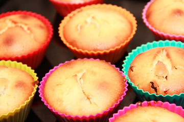 baked biscuit yellow edible cupcakes in multi-colored a silicone forms