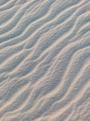Beach sand texture with shadows and waves