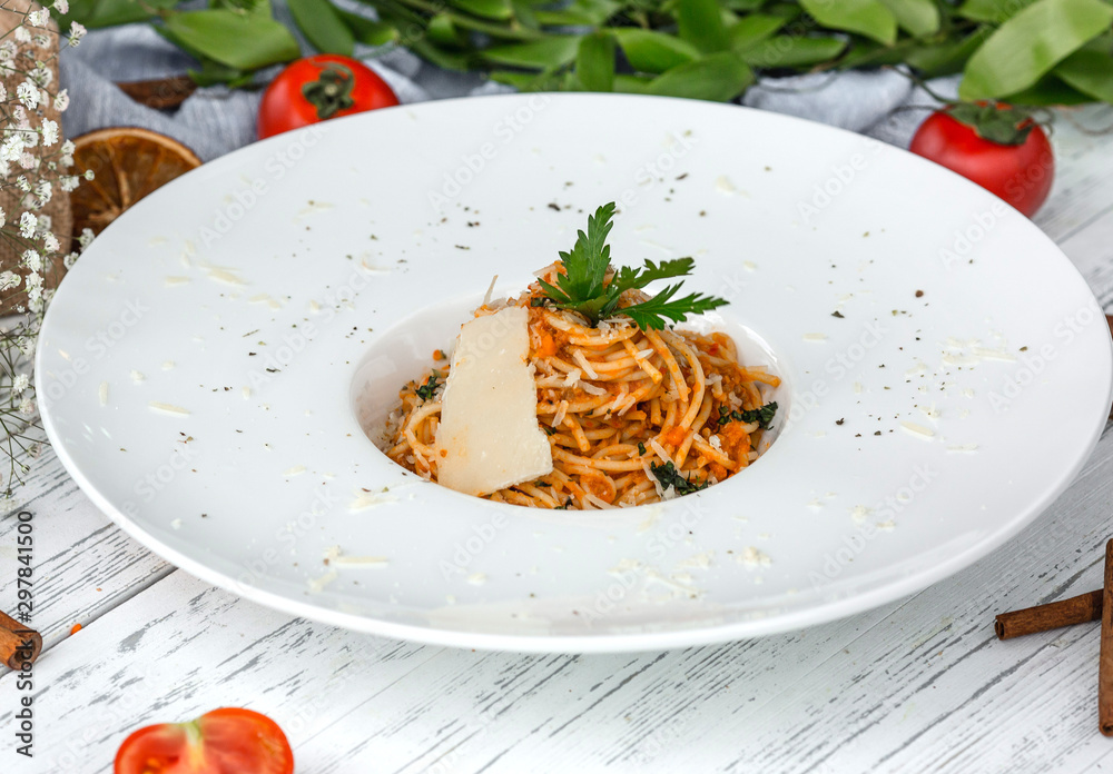 Poster creamy carrot spaghetti with tomato, garnished with parsley and parmesan