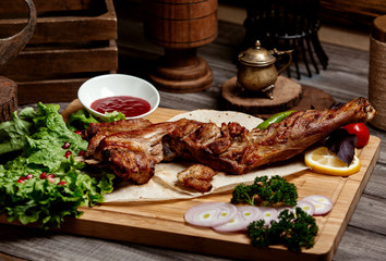 fried meat kebab on wooden board with lavash