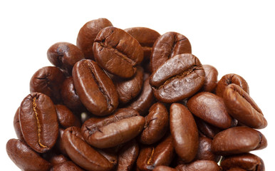 Coffee beans in close up view. Coffee background. Partly isolated on white. Soft focus view.