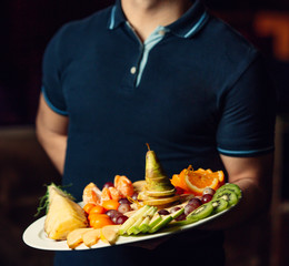 fruit plate in man hands