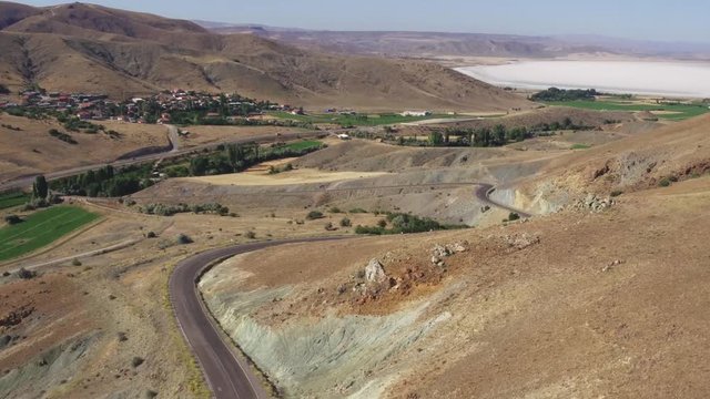 Large salt lake / Big Saline Lake in turkish dry mountains landscape / Summer sunny hot day at cloudless sky