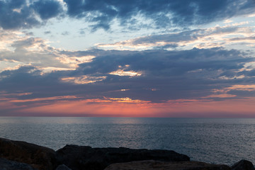 sunset on the sea, the sun in the clouds