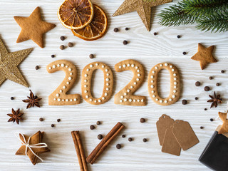 Ginger biscuits of the form of numbers and 2020 new year ginger cookies white wood background. Top view. Seasonal packaging, spices and New Year's attributes