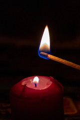 Mit Streichholz entzündete Kerzen erleuchten die dunkle Adventszeit in der Vorweihnachtszeit und...