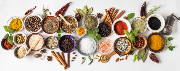 Various dry spices in small bowls and raw herbs flat lay on white background. Top view, - obrazy, fototapety, plakaty