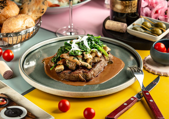 lamb steak topped with sauteed mushroom and spinach