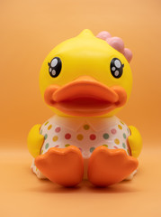 Cute yellow duck doll Wearing a colorful  dot shirt
