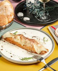 long pie on cream garnished with thin slices of pineapple topped with cinnamon