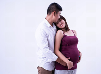 Naklejka premium The pregnant woman lean on shoulder of her husband,hand touch belly together,feeling loved and care