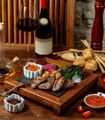 marinated beef steak pieces with baby potatoes, onion, fresh herbs and tomato sauce