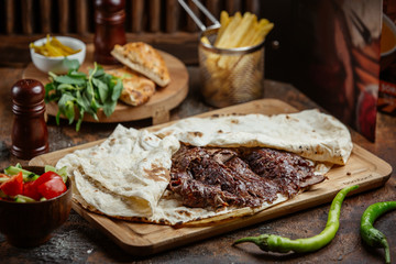 meat doner with lavash on wooden board