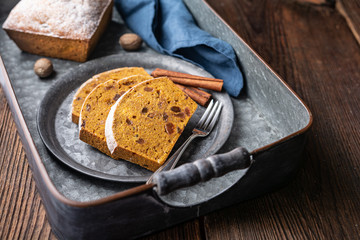 Sweet whole grain pumpkin bread slices with raisins, sprinkled with powdered sugar