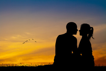 Fototapeta na wymiar couple kissing at sunset