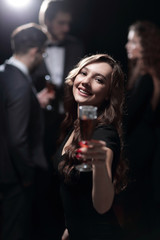 happy young woman raising glass in toast