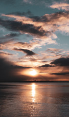 Stunningly beautiful sunrise, taken on a cloudy morning from Salthill beach near Galway, Ireland. Showing the calm water of Galway Bay and Mutton Island in the distance.