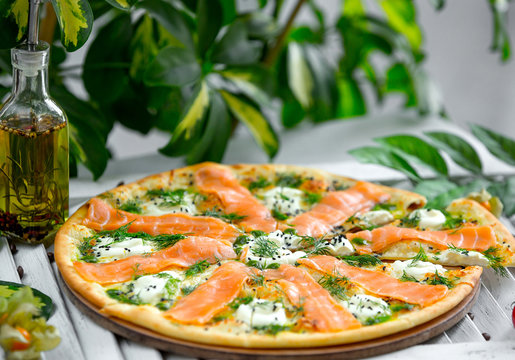 pizza with salmon and mozzarella on the table