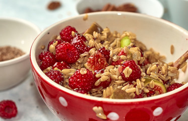 oatmeal for breakfast with raspberries, nuts and seeds