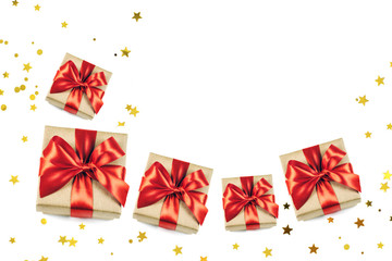 Festive gift boxes with red ribbon bow isolated on white sparkling background. Flat lay style.