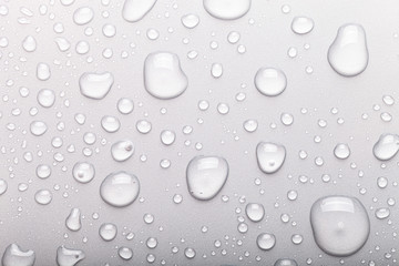 Drops of water on a color background. Selective focus. Gray