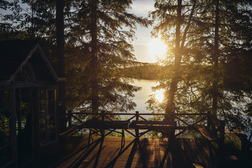 Sunset lake view from a typical summer cottage with sauna in Finland.