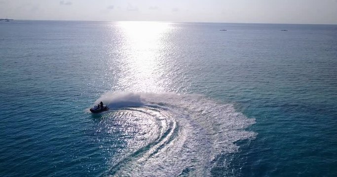 Aerial view of a jet ski tracking on seawater, speed recreation in urban waters of the Ko Mak island, Thailand