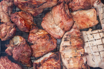 Closeup grilling meat over charcoal stove outdoor