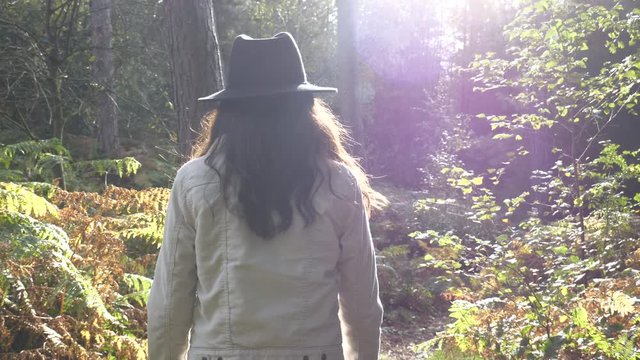 Back View Young Trendy Woman Walking In Sunny Forest Alone