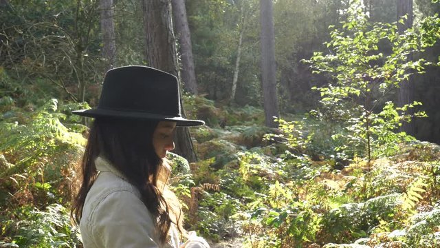 Beautiful Young Woman In The Forest Turns And Smiles