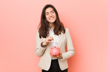 Young caucasian woman holding a piggy bank