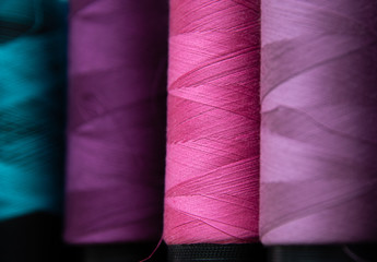 Macro and abstract background of purple, pink, lilac and green Industrial sewing thread