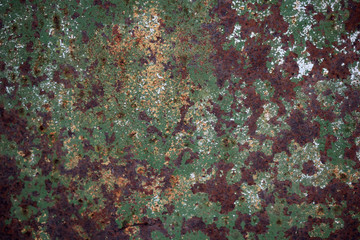 Текстура ржавой железной покрытой облупившейся зеленой краской стены.